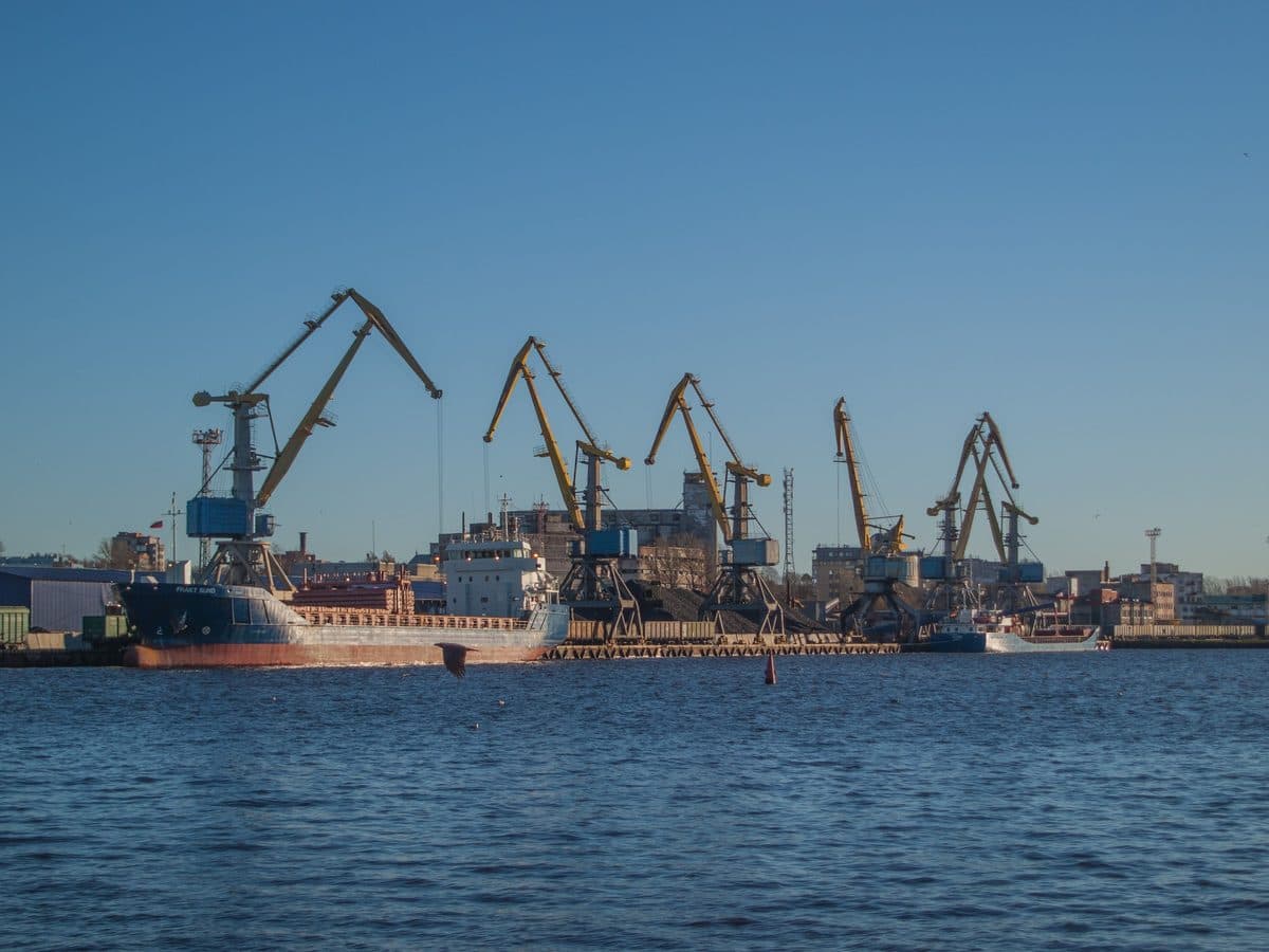 Dockside cranes and a moored freight ship at a cargo port